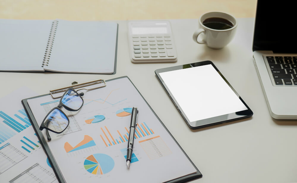 Dossier d'audit de performance sur un bureau avec des graphiques financiers.