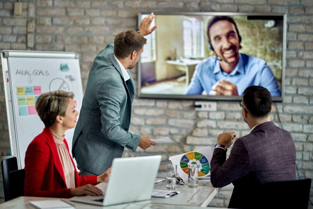 Un point stratégique en visioconférence entre un entrepreneur du web et une agence commerciale externe.