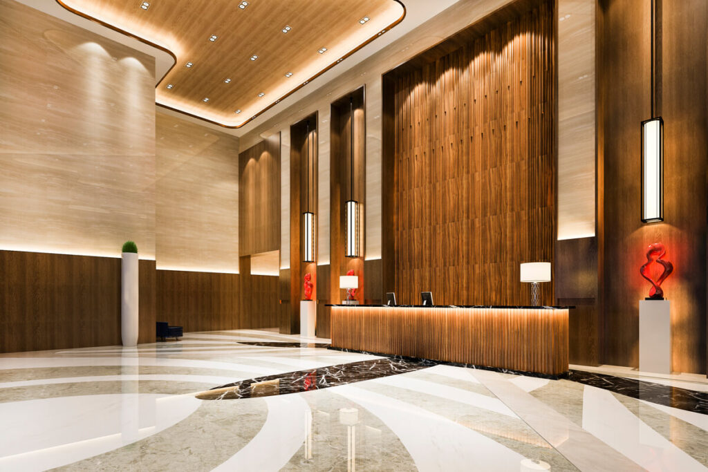 Un grand hall d'accueil d'entreprise haut de gamme au design épuré inspiré des codes d'un grand hôtel.