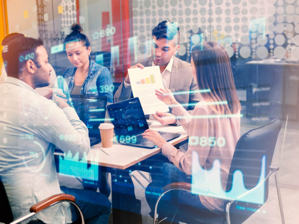 Équipe de cadres analysant des données stratégiques générées par une intelligence artificielle.