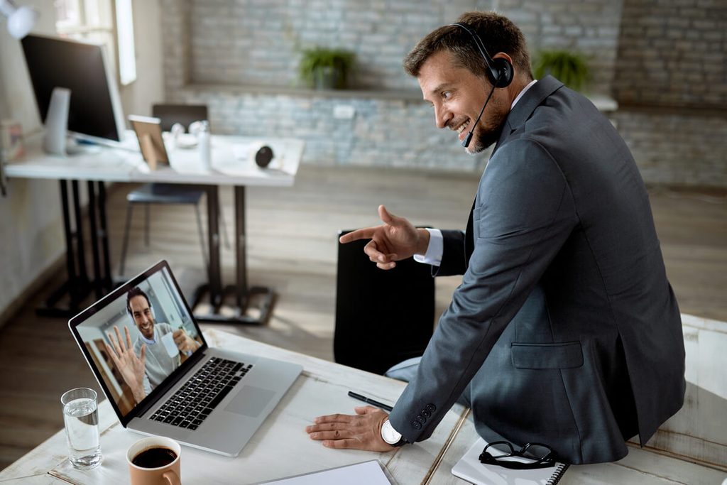 Responsable commercial en visioconférence menant un rendez-vous client obtenu via une campagne IA.